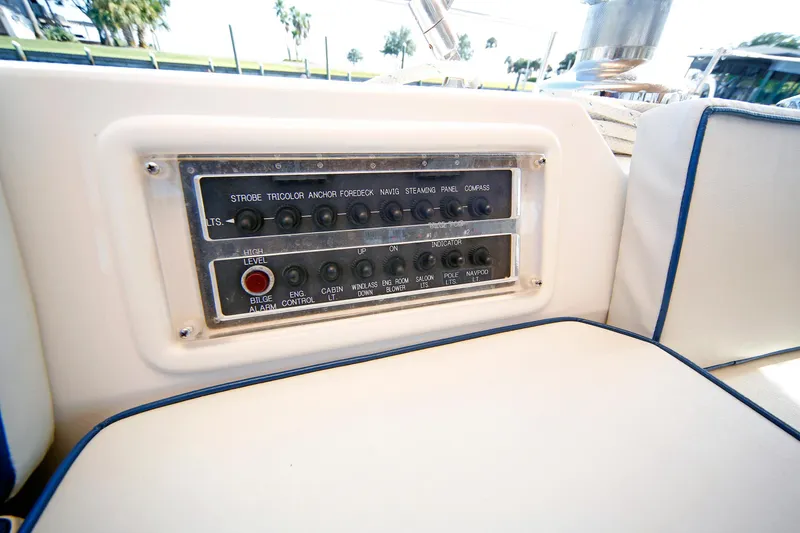 Slide: The Image of Control panel on a 2012 Hylas 49CC yacht, featuring various switches and indicators. - 93