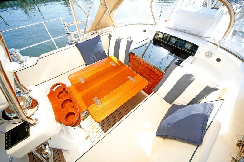 Slide: The Image of Luxurious 2012 Hylas 49CC yacht cockpit with wooden table and plush seating. - 98