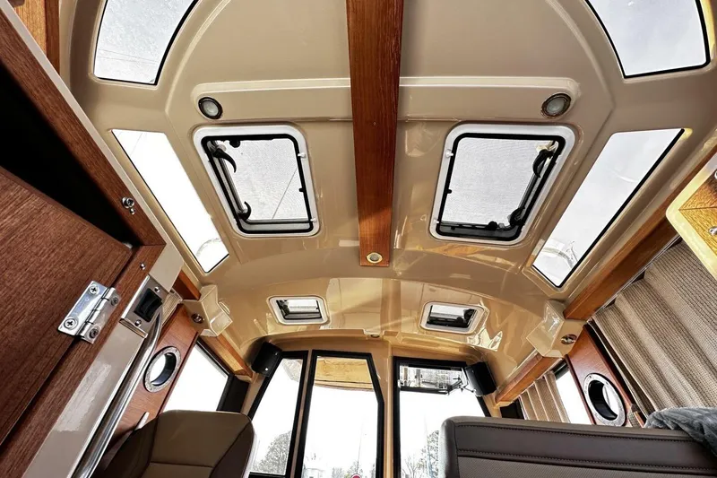 Slide: The Image of Interior view of 2019 Ranger Tugs R-23 boat, featuring skylights and wood accents. - 12