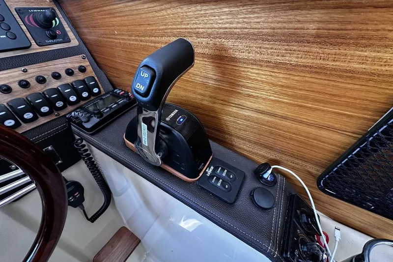 Slide: The Image of 2019 Ranger Tugs R-23 boat control panel with throttle and switches. - 17