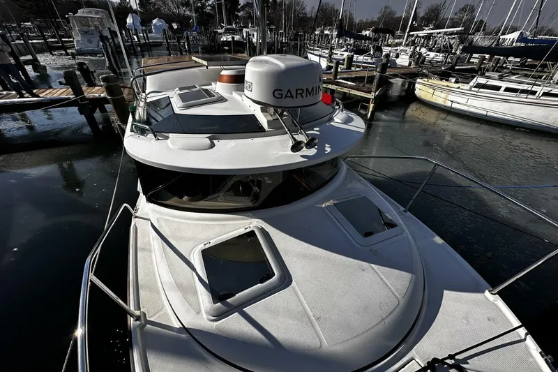 Slide: The Image of 2019 Ranger Tugs R-23 boat docked in a marina, featuring Garmin equipment. - 23