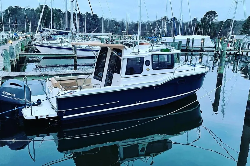 Slide: The Image of 2019 Ranger Tugs R-23 boat docked in a marina with Yamaha outboard motor. - 29
