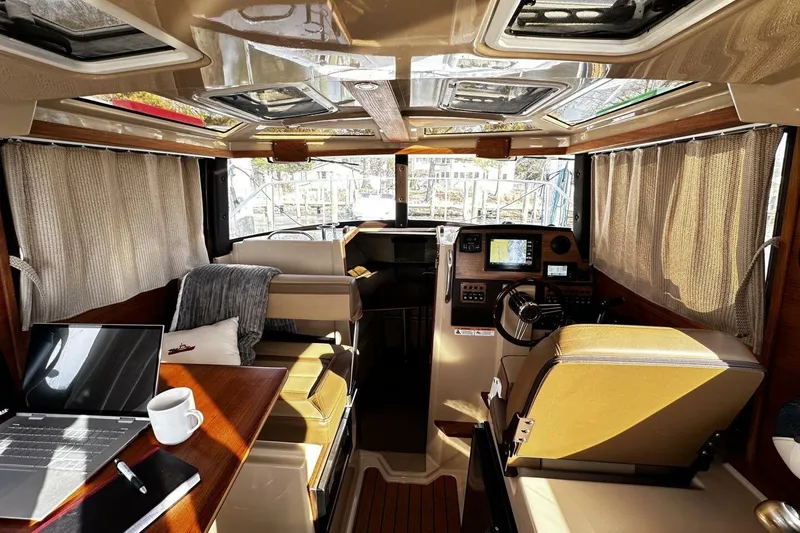 Slide: The Image of 2019 Ranger Tugs R-23 boat interior with helm, seating, and navigation equipment. - 5