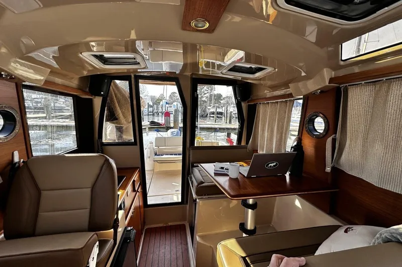 Slide: The Image of Interior of 2019 Ranger Tugs R-23 boat with seating, table, and windows. - 6