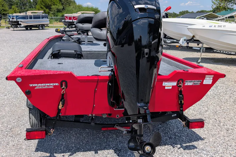 Slide: The Image of 2026 Tracker Pro Team 175 Crappie Edition boat, red exterior, parked on gravel lot. - 3