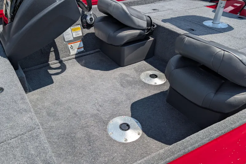 Slide: The Image of 2026 Tracker Pro Team 175 Crappie Edition boat interior with gray carpet and black seats. - 6