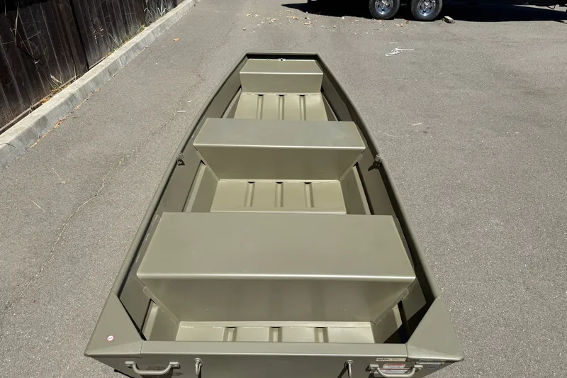 Slide: The Image of 2026 Tracker Grizzly 12 Jon boat on pavement, showcasing its sturdy, minimalist design. - 4