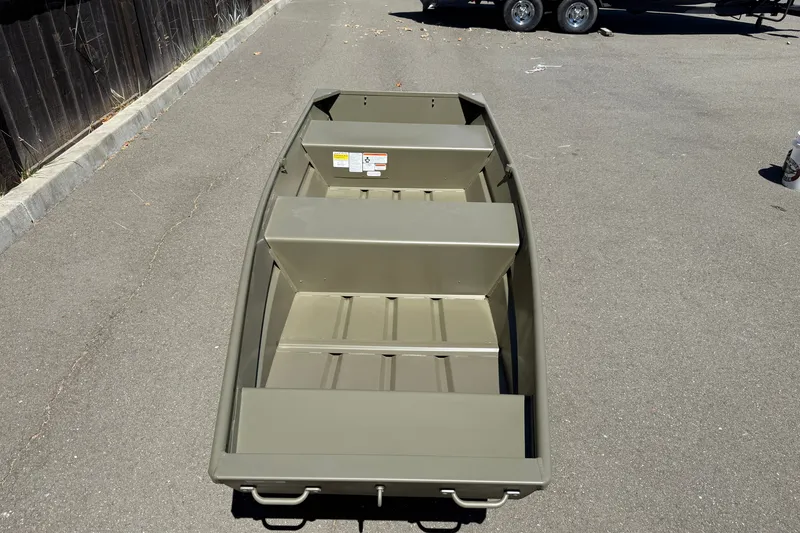 Slide: The Image of 2026 Tracker Grizzly 12 Jon boat on pavement, showcasing interior seating and design. - 6