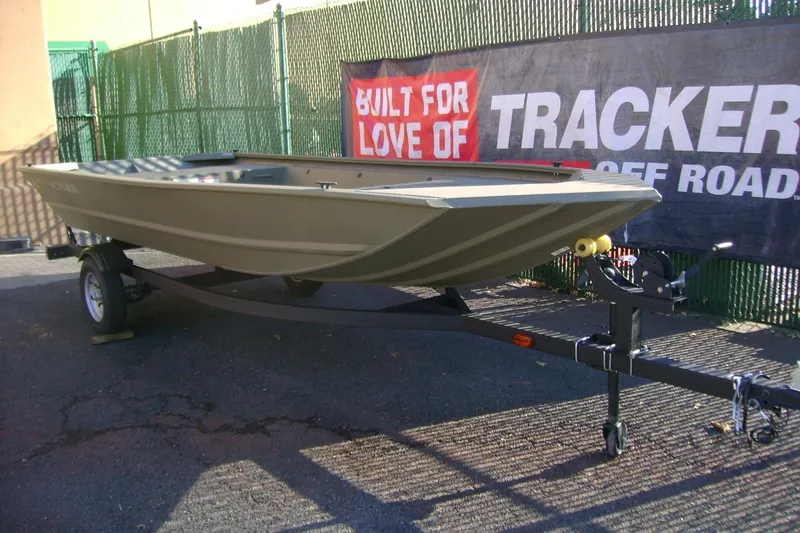 Slide: The Image of 2026 Tracker Grizzly 1648 Utility boat on trailer, displayed outdoors. - 2