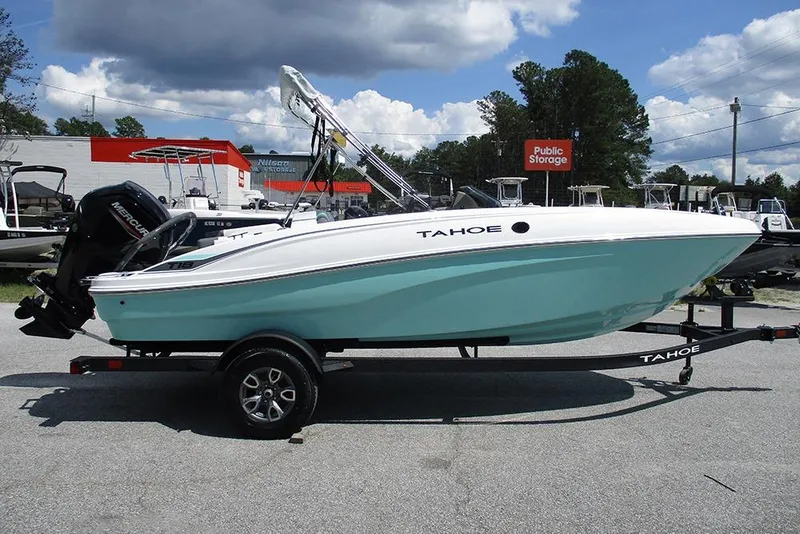 The Image of 2026 Tahoe T18 boat on trailer, parked outdoors under cloudy sky. - 1