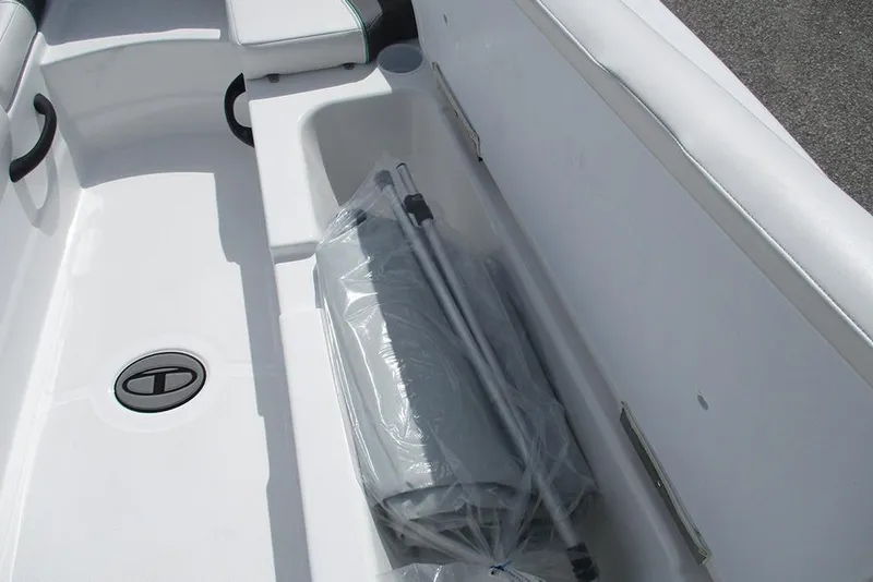 Slide: The Image of 2026 Tahoe T18 boat interior storage compartment with packaged accessories. - 14