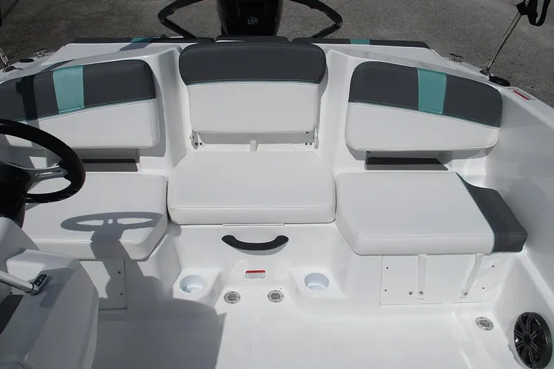 Slide: The Image of 2026 Tahoe T18 boat interior with white and gray seating, steering wheel visible. - 16