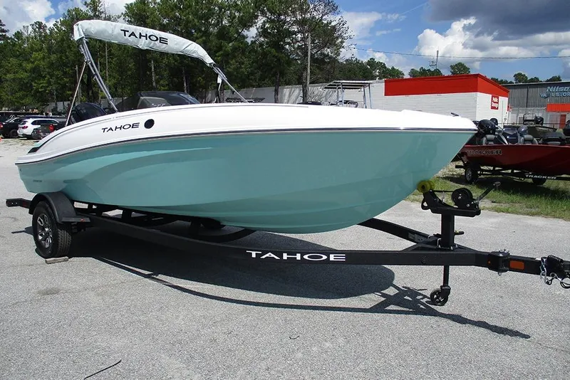 Slide: The Image of 2026 Tahoe T18 boat on trailer, parked outdoors under a cloudy sky. - 3