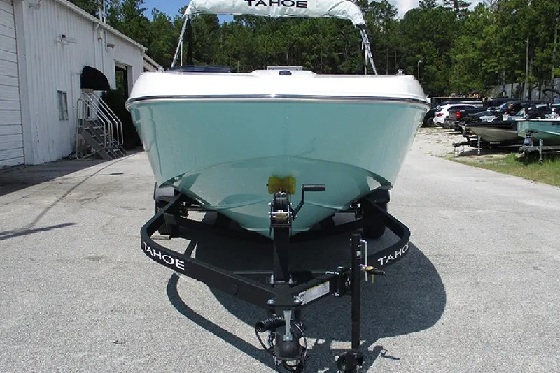 Slide: The Image of 2026 Tahoe T18 boat on trailer, parked outdoors near a building. - 4