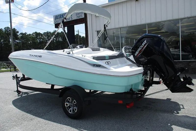 Slide: The Image of 2026 Tahoe T18 boat with Mercury engine on trailer, parked outside dealership. - 7