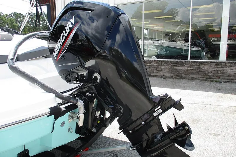 Slide: The Image of 2026 Tahoe T18 boat with Mercury outboard motor, displayed outside a showroom. - 9
