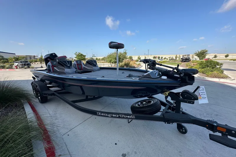 Slide: The Image of 2025 Ranger ALPHA 208 fishing boat on trailer, parked outdoors under clear blue sky. - 3