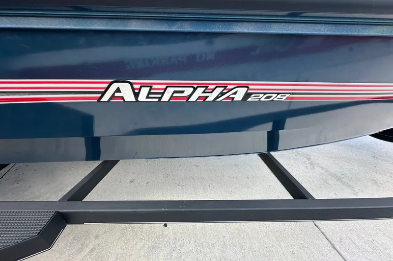 Slide: The Image of 2025 Ranger ALPHA 208 boat with red and white stripes on a trailer. - 14