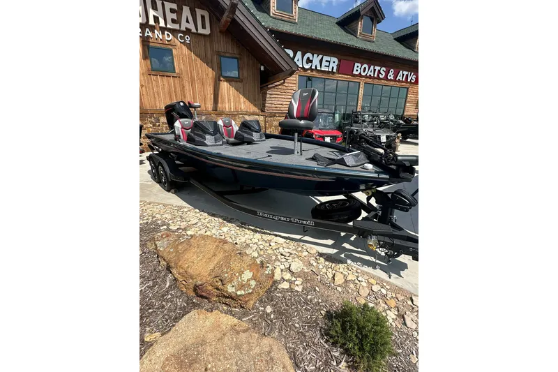 The Image of 2025 Ranger ALPHA 208 boat displayed outside a dealership, featuring sleek design and modern seating. - 0