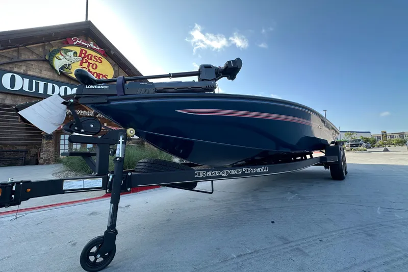 Slide: The Image of 2025 Ranger ALPHA 208 boat on trailer outside Bass Pro Shops. - 2