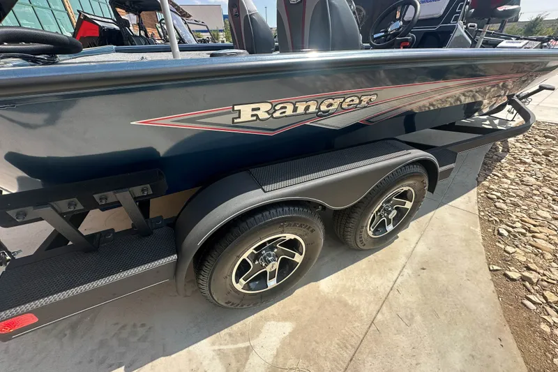 Slide: The Image of 2025 Ranger ALPHA 208 boat with dual-axle trailer, sleek design, and modern features. - 3