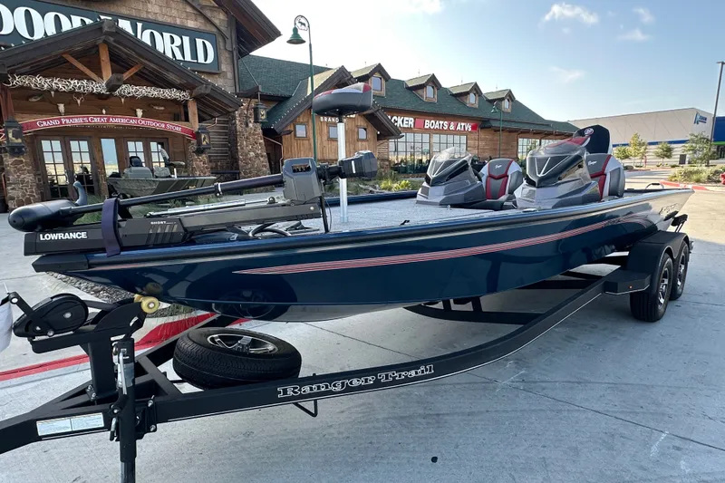 Slide: The Image of 2025 Ranger ALPHA 208 boat on trailer outside outdoor store. - 1