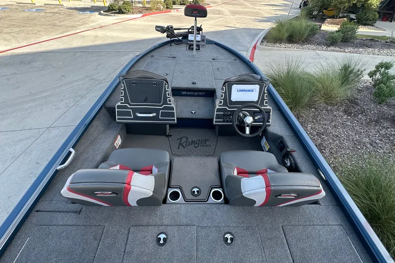 Slide: The Image of 2025 Ranger ALPHA 208 boat interior with dual seats, steering wheel, and navigation system. - 23
