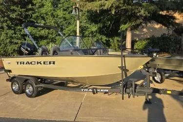 Slide: The Image of 2026 Tracker Targa V-18 Combo boat on trailer, parked outdoors. - 6