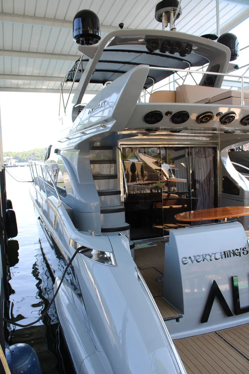 Slide: The Image of Luxury 2006 Azimut 50 yacht docked, showcasing sleek design and spacious deck area. - 11