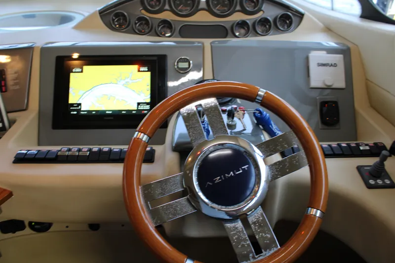 Slide: The Image of Steering wheel and dashboard of a 2006 Azimut 50 yacht with navigation display. - 15