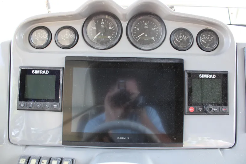Slide: The Image of Control panel of a 2006 Azimut 50 yacht with Simrad and Garmin displays. - 18