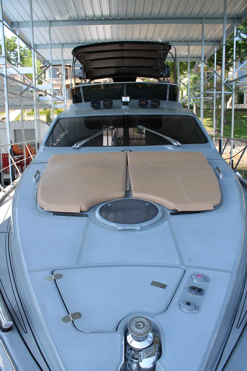 Slide: The Image of 2006 Azimut 50 yacht with sunbathing deck, docked under a covered marina. - 19