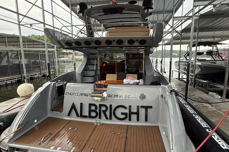 Slide: The Image of Azimut 50 yacht from 2006 docked, featuring a spacious deck and elegant design. - 2