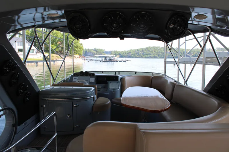 Slide: The Image of Interior view of a 2006 Azimut 50 yacht with seating and table, overlooking a serene waterfront. - 21