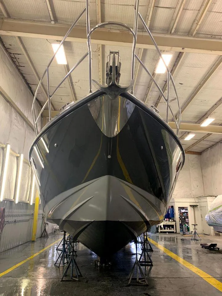 Slide: The Image of 2006 Azimut 50 yacht in a maintenance facility, viewed from the front. - 25