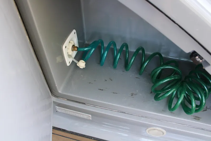 Slide: The Image of Coiled green hose in storage compartment of 2006 Azimut 50 yacht. - 32