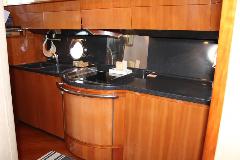 Slide: The Image of Luxurious kitchen interior of a 2006 Azimut 50 yacht with wood cabinetry and sleek countertops. - 42