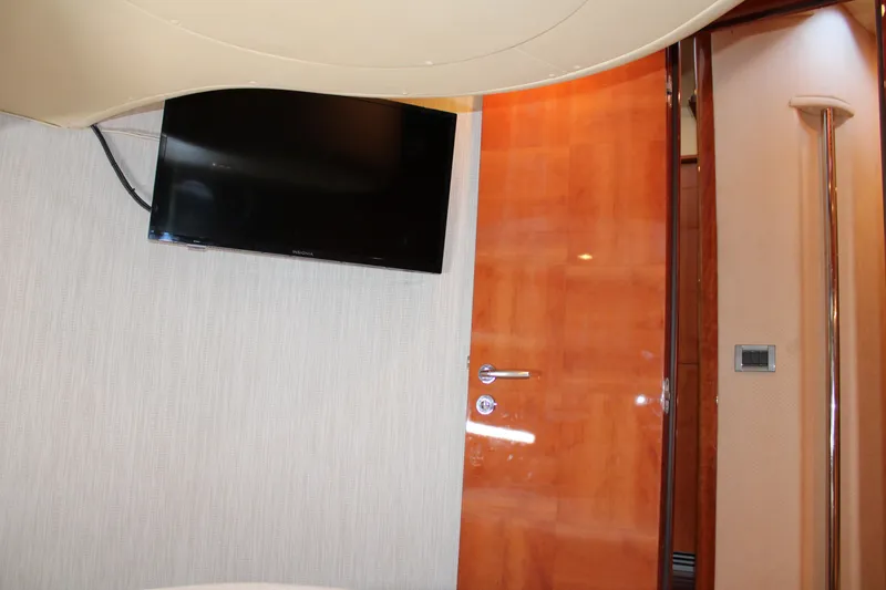 Slide: The Image of Interior of 2006 Azimut 50 yacht with wall-mounted TV and wooden door. - 44