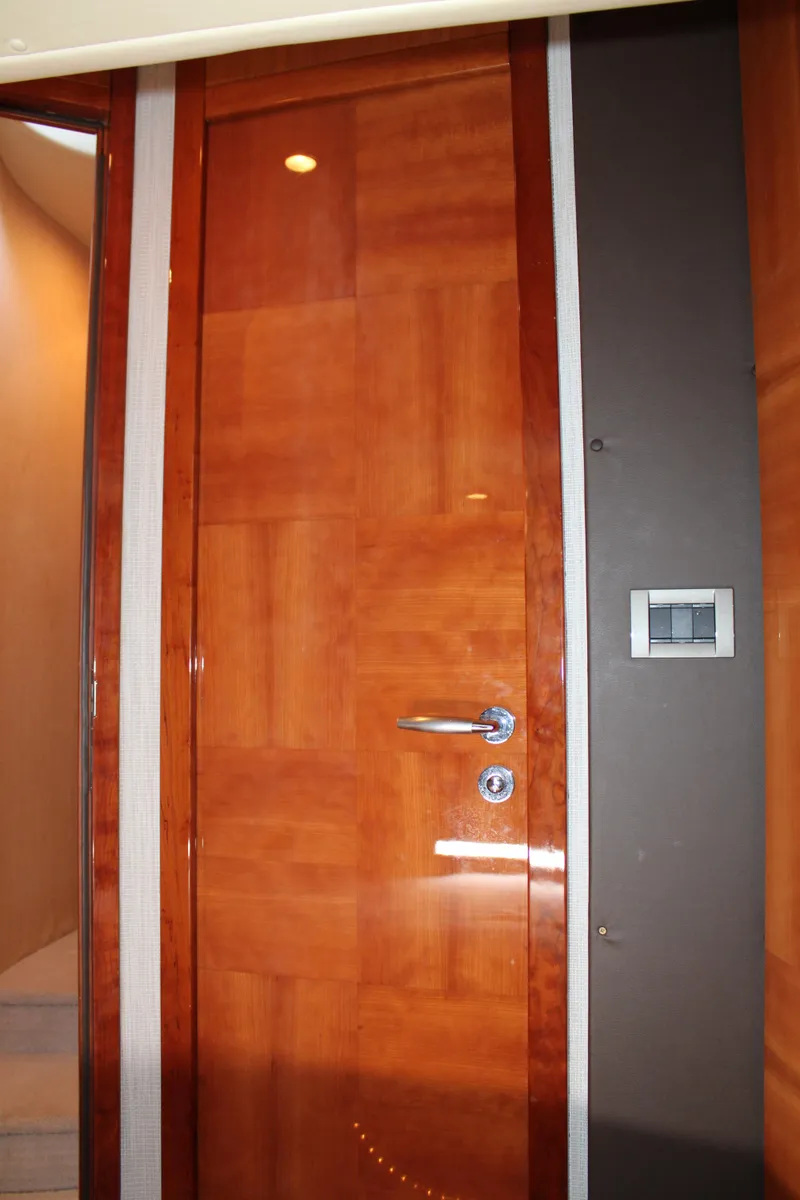Slide: The Image of Wooden interior door on a 2006 Azimut 50 yacht, featuring sleek design and modern handle. - 45