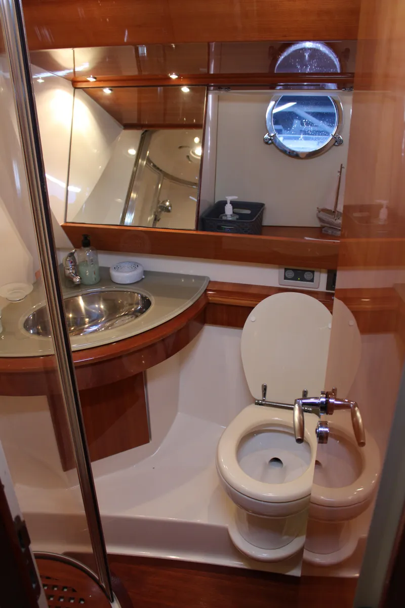 Slide: The Image of Luxurious bathroom in 2006 Azimut 50 yacht with modern fixtures and porthole window. - 46