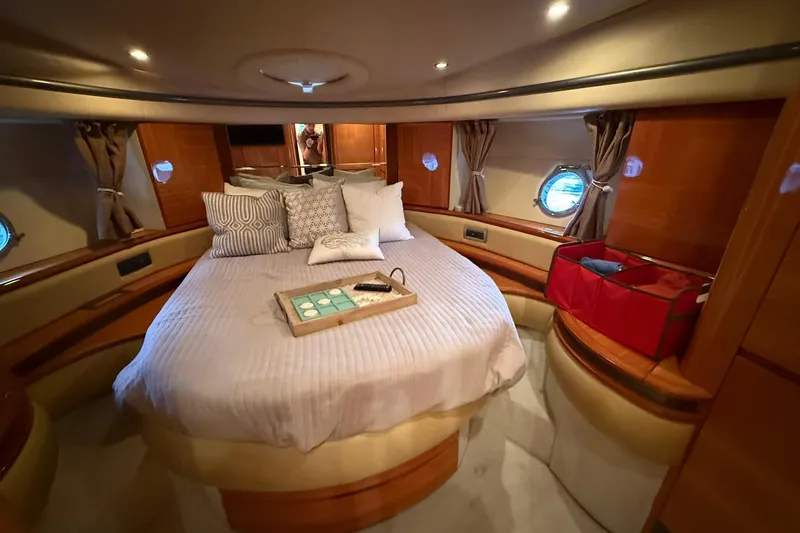 Slide: The Image of Luxurious cabin interior of a 2006 Azimut 50 yacht with cozy bedding and elegant decor. - 59