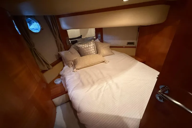 Slide: The Image of Luxurious bedroom interior of a 2006 Azimut 50 yacht with elegant bedding. - 60