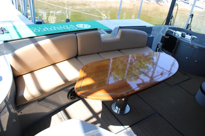 Slide: The Image of Luxurious seating area on a 2006 Azimut 50 yacht with polished wooden table. - 9