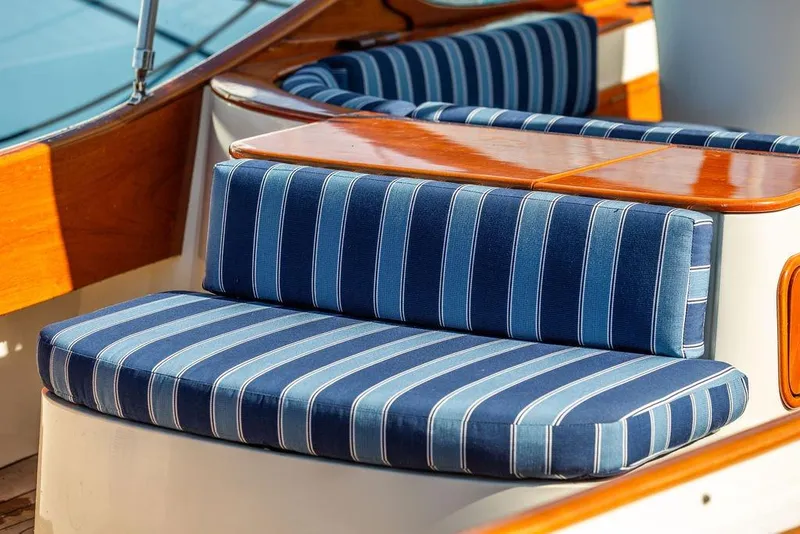Slide: The Image of Blue striped seating on 2003 Hinckley T29R boat with polished wood accents. - 13