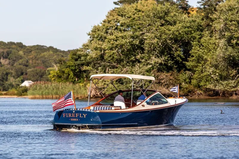 Slide: The Image of 2003 Hinckley T29R boat "Firefly" cruising on a scenic river. - 3