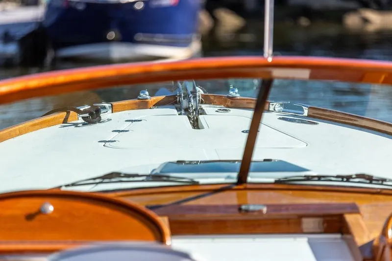 Slide: The Image of Close-up of 2003 Hinckley T29R boat dashboard with wooden trim and clear windshield. - 7