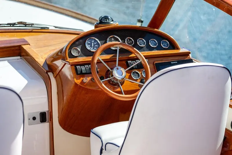 Slide: The Image of 2003 Hinckley T29R boat helm with wooden dashboard and steering wheel. - 8