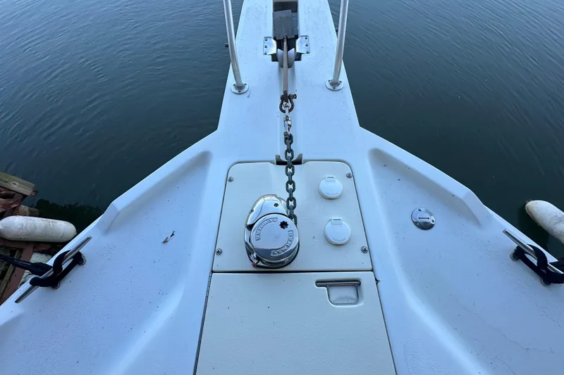 Slide: The Image of 1996 Mainship 40 Sedan Bridge helm with white seating and control panel. - 10