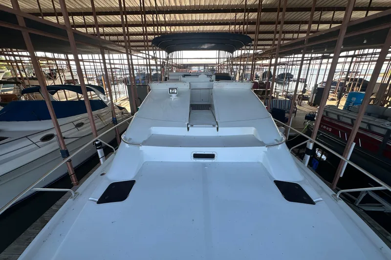 Slide: The Image of Bow of 1996 Mainship 40 Sedan Bridge with anchor chain and water view. - 11