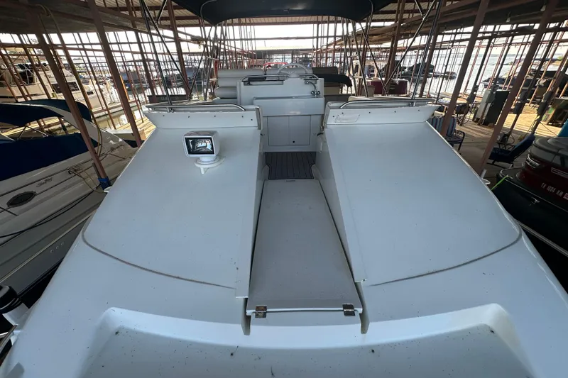 Slide: The Image of 1996 Mainship 40 Sedan Bridge docked in a covered marina, showcasing its sleek design. - 12